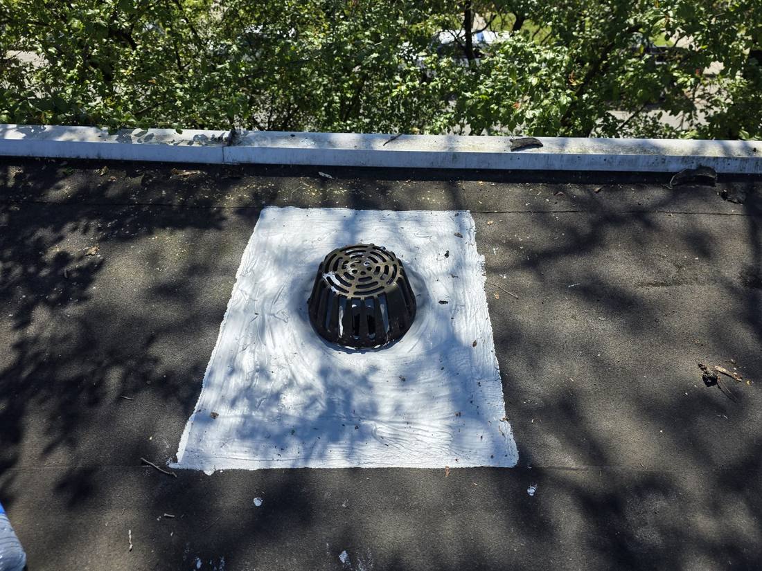 Freshly sealed roof drain during a maintenance visit