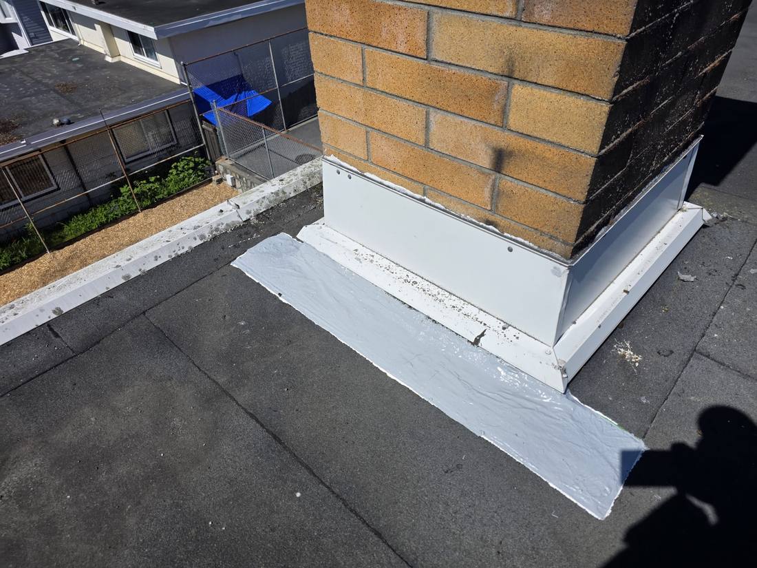 New flashing sealed around a rooftop mechanical unit